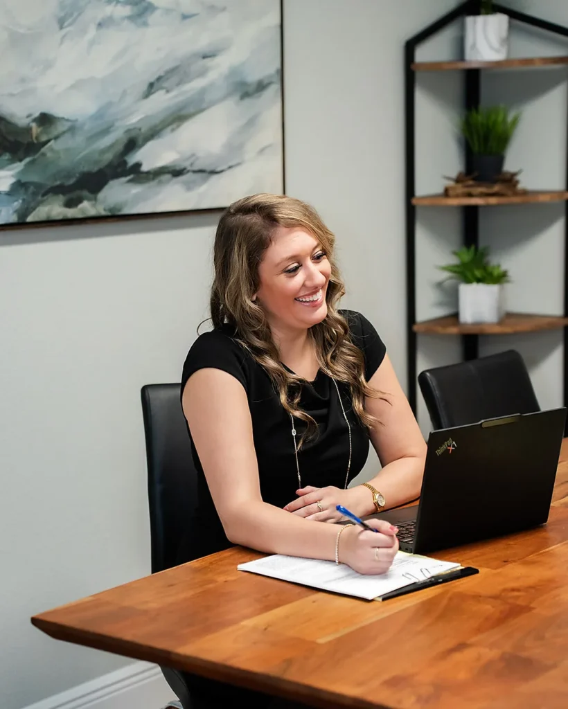 Lynna Comunale reviewing child support figures at Catey & Maguire Law in New Port Richey, Florida